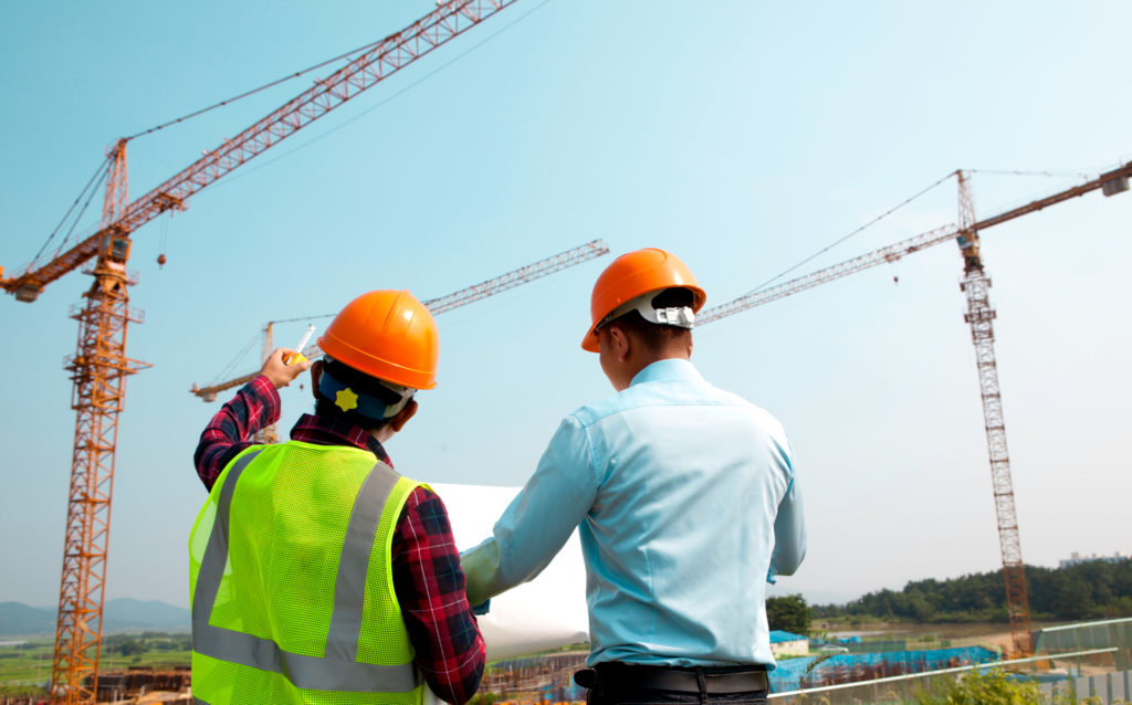 construction workers surveying the land