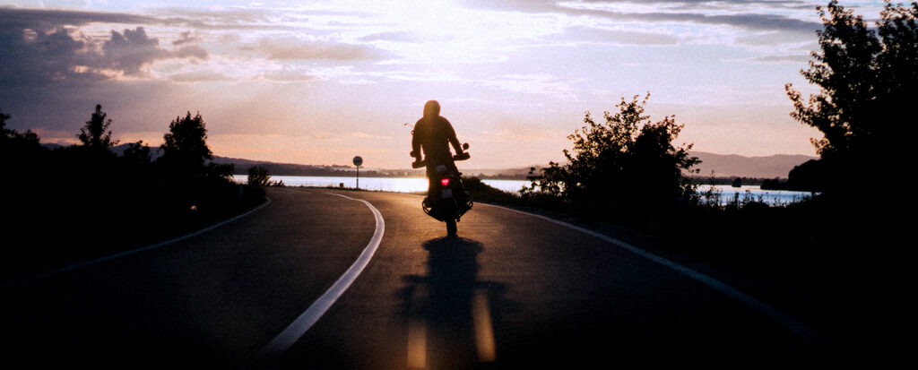 motorcycle on road during sunset
